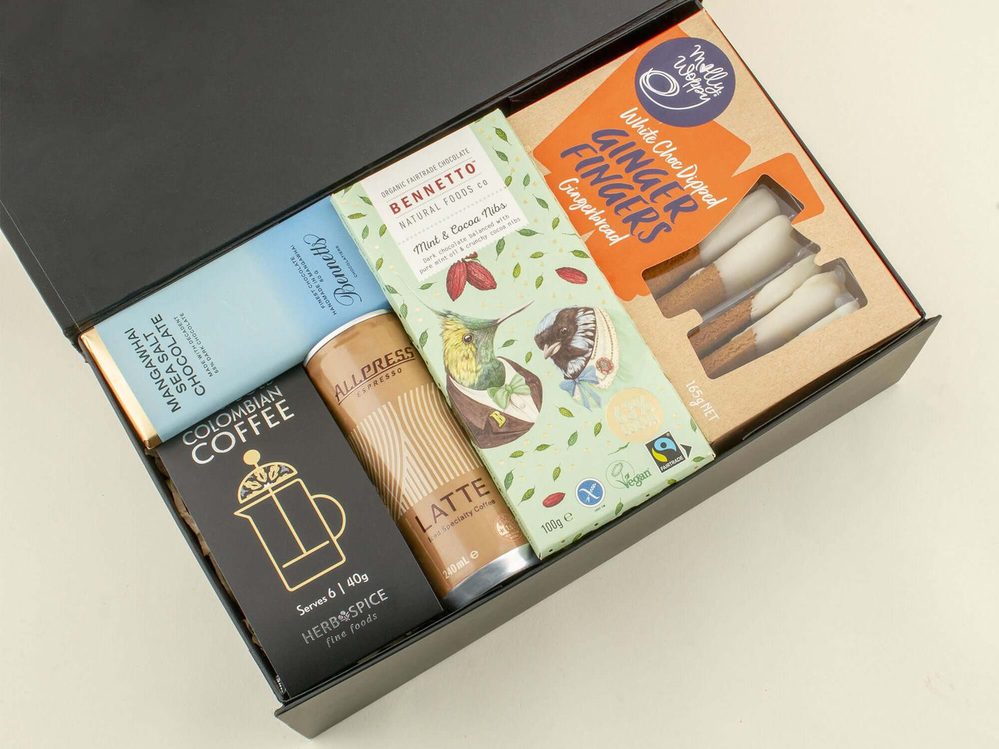 A beautifully arranged Coffee Lover's Gift Box featuring coffee, latte, and artisan ginger biscuits.