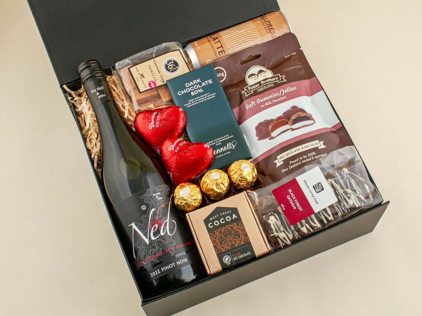 Guilty Treats Gift Box featuring wine, chocolates, cocoa, and sweets, perfect for chocolate lovers.