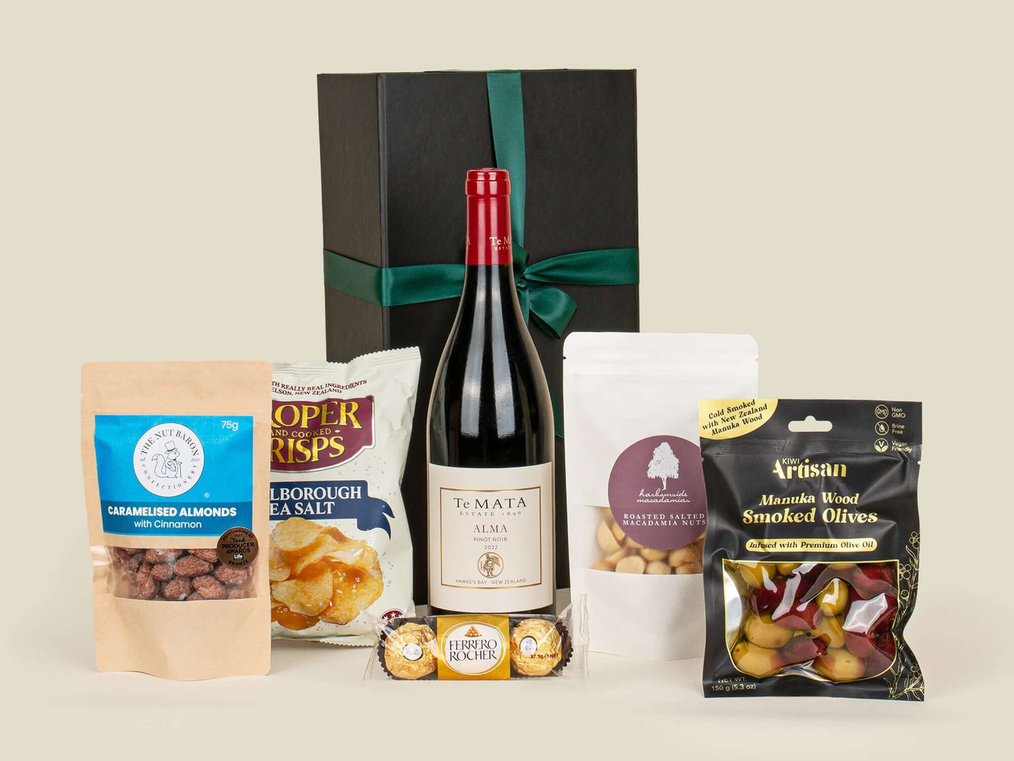 Wine bottle with assorted snacks on a light background