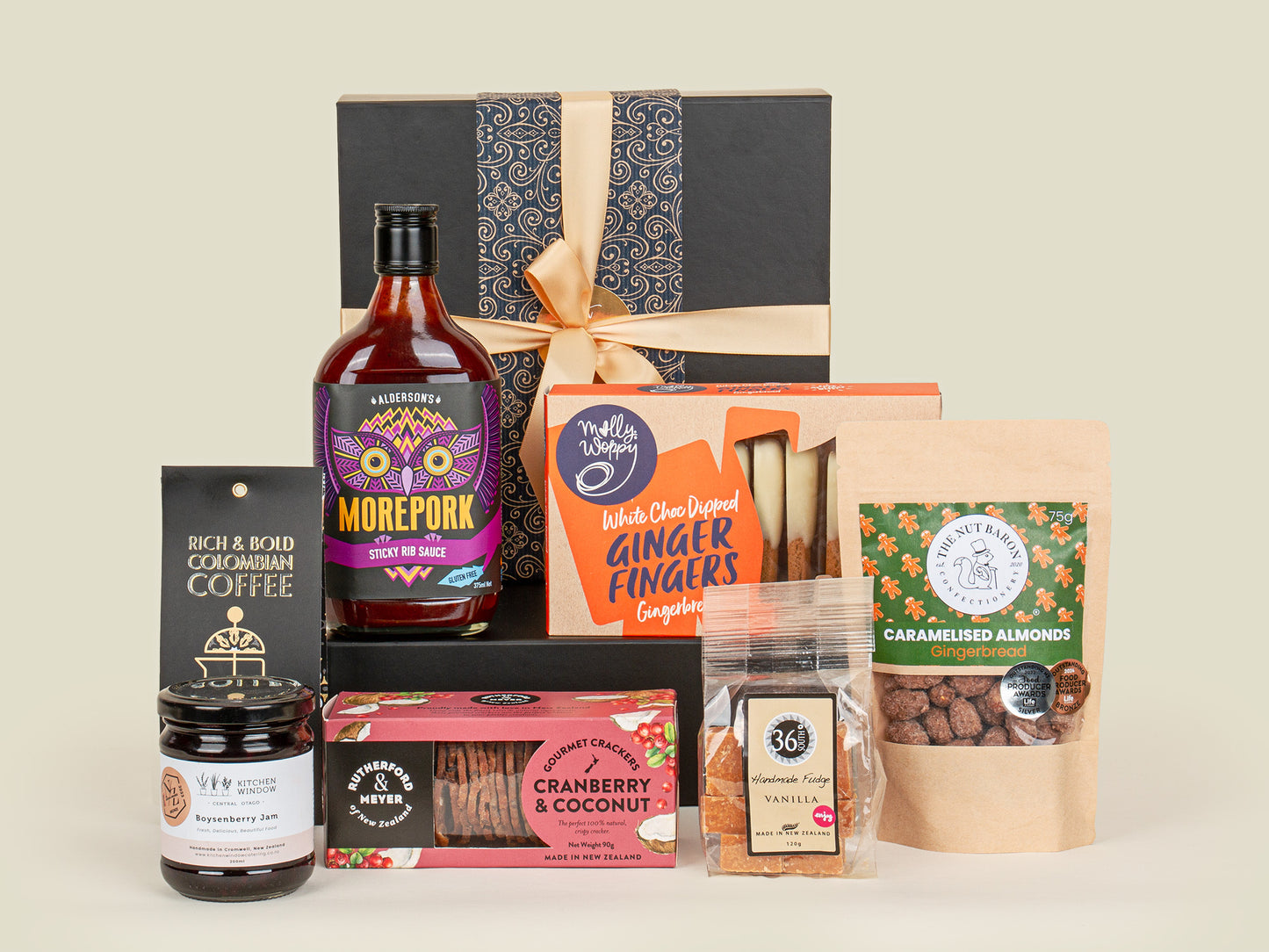 Gourmet Food Gift Box- Oh Goodie  Assorted gourmet food and drink products including a bottle of Morepork gin, coffee, and snacks on a light background.