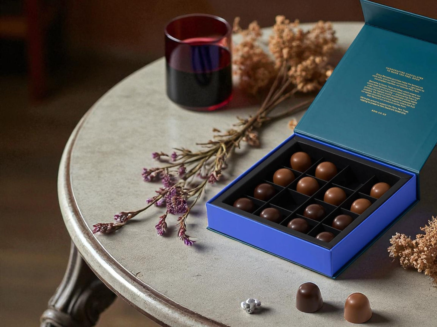 Box of Bennetts Chocolate on a coffee table with dried flowers