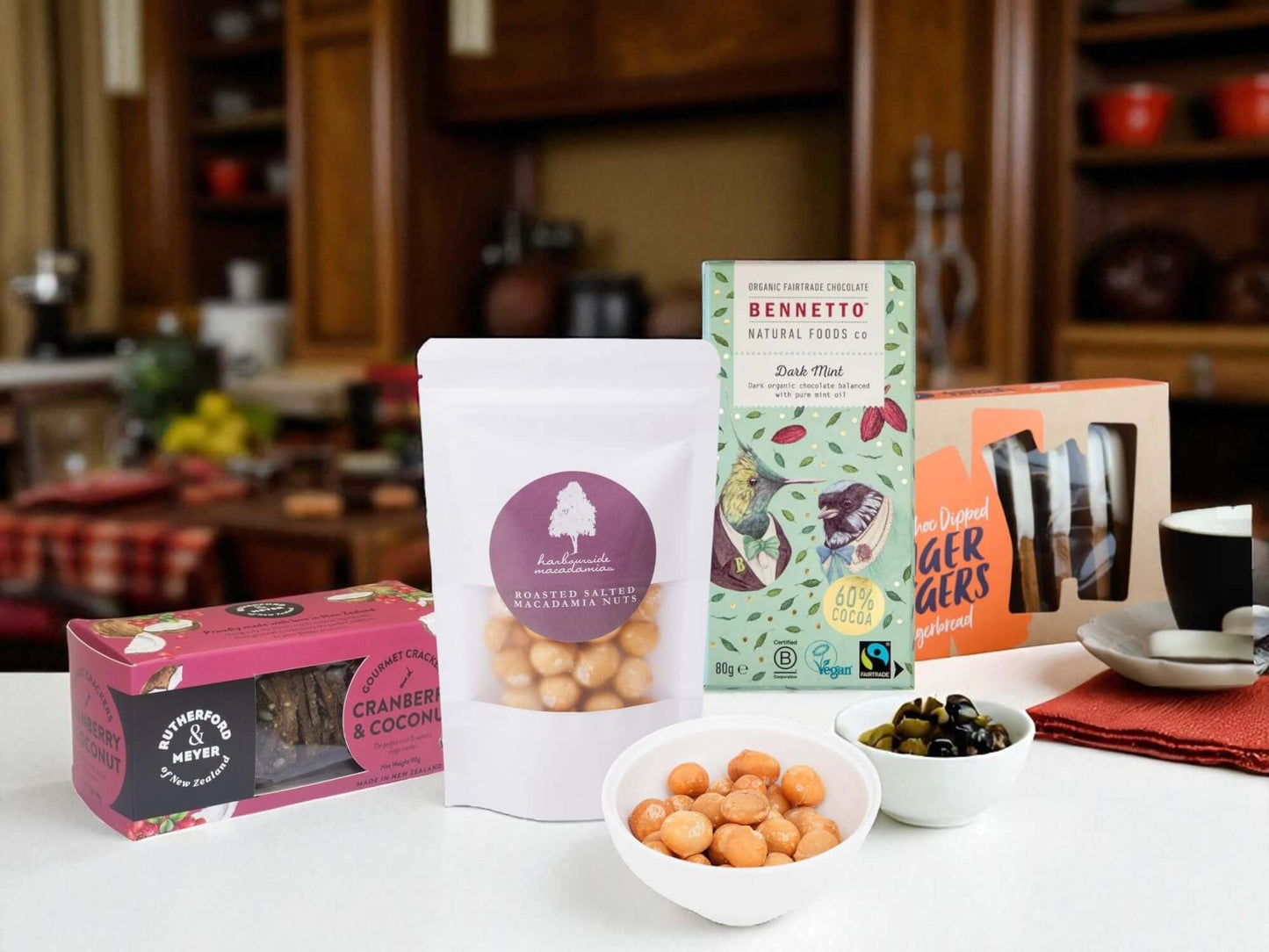 Assorted snacks and tea packages on a kitchen counter with blurred background