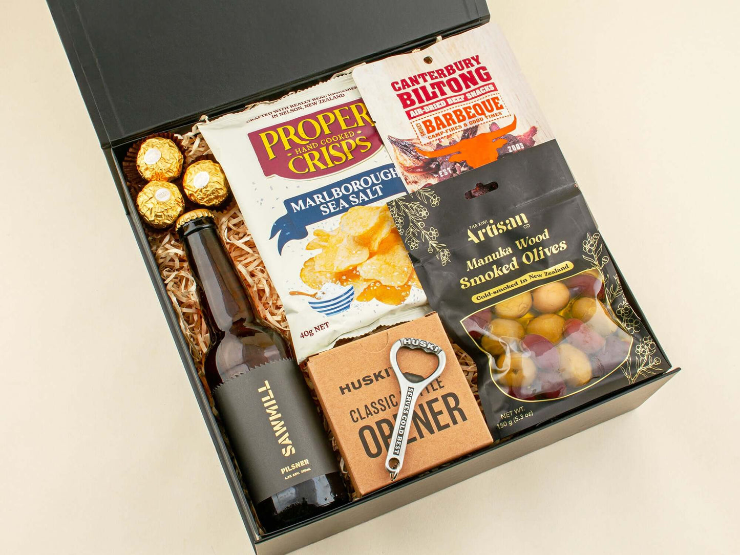 BeerTop Gift Box featuring snacks, craft beer, smoked olives, and a Huski opener.