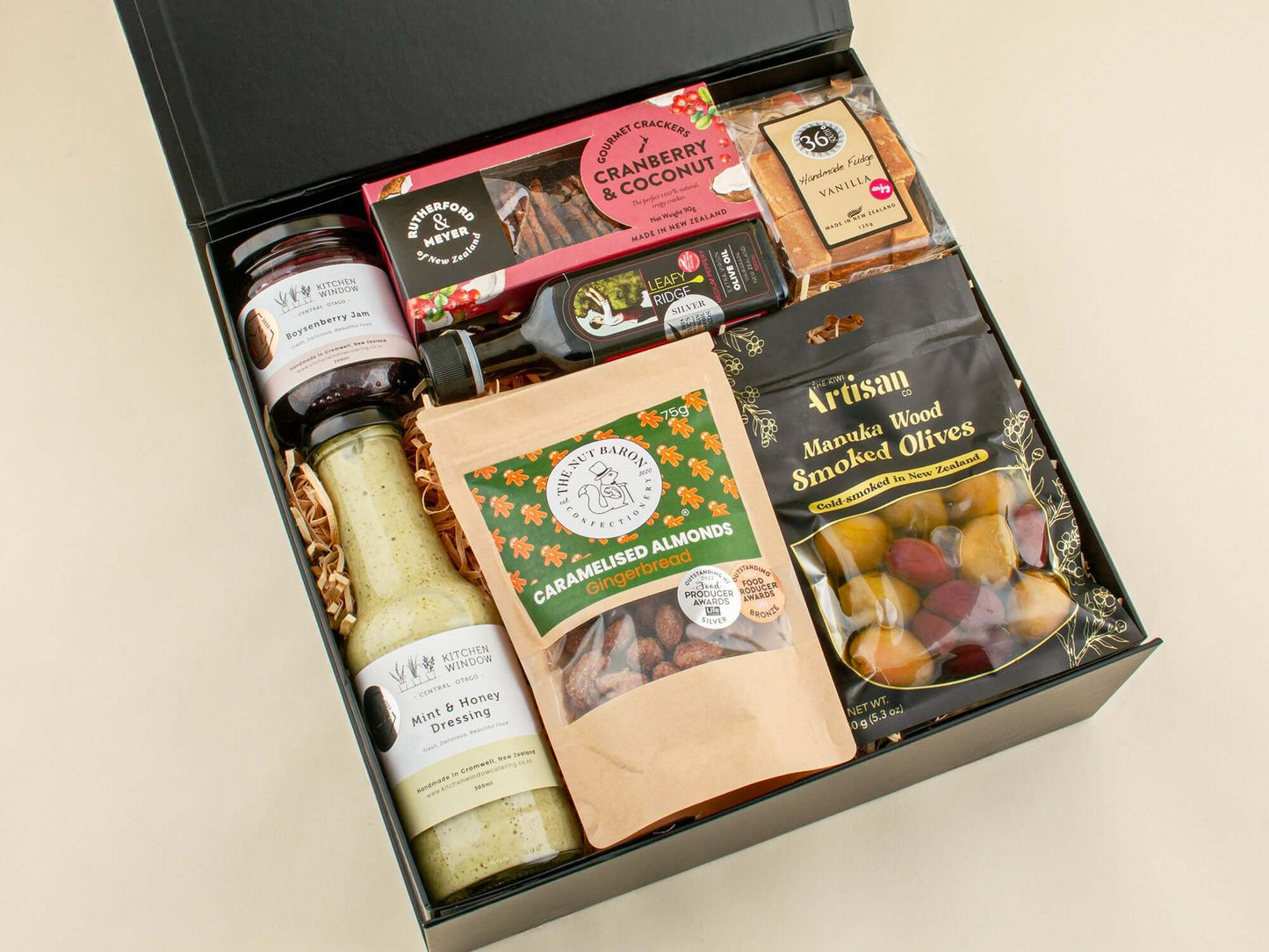Kitchen Conversations Gift Box featuring Kiwi gourmet products, including olives, nuts, and snacks arranged in a stylish hamper.