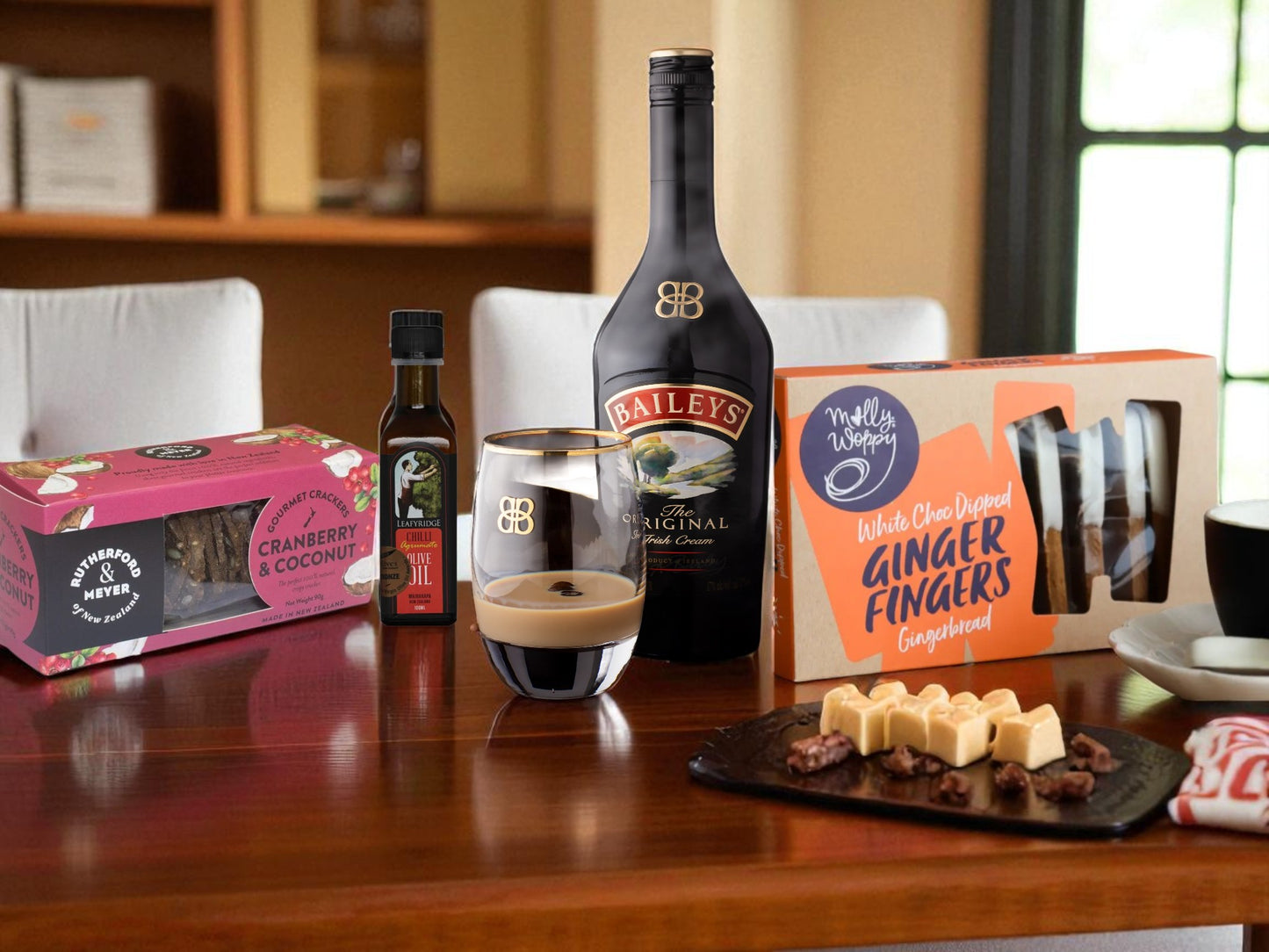 Table with Baileys bottle, coffee, and snacks in a cozy room setting