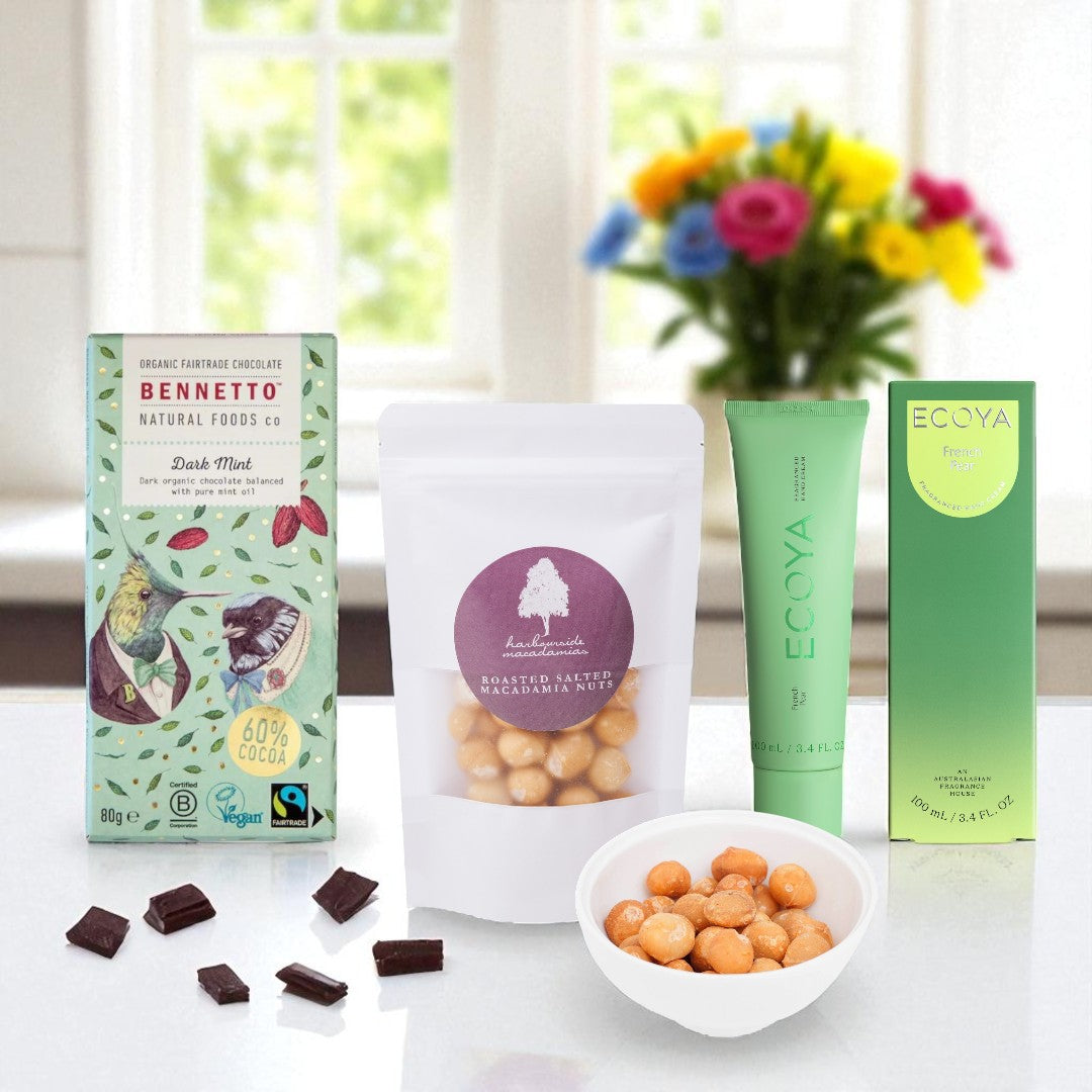 Assorted green products including chocolate, nuts, and a skincare product on a white surface with a blurred background.
