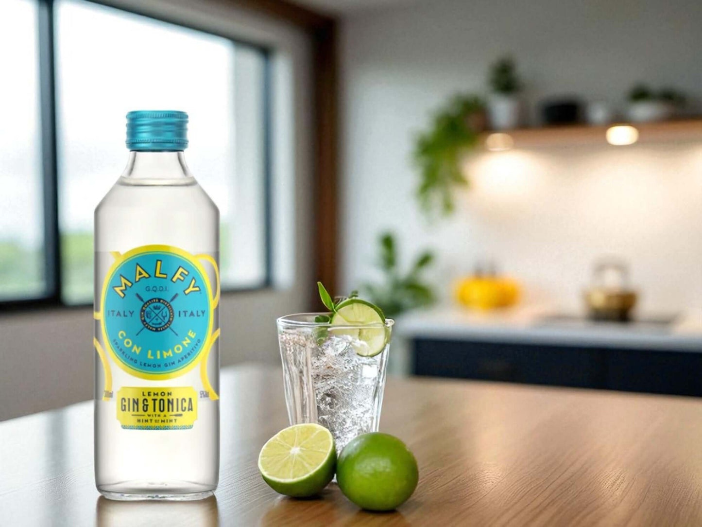 Bottle of Malfy Gin Tonica with a glass of gin and tonic on a kitchen counter.